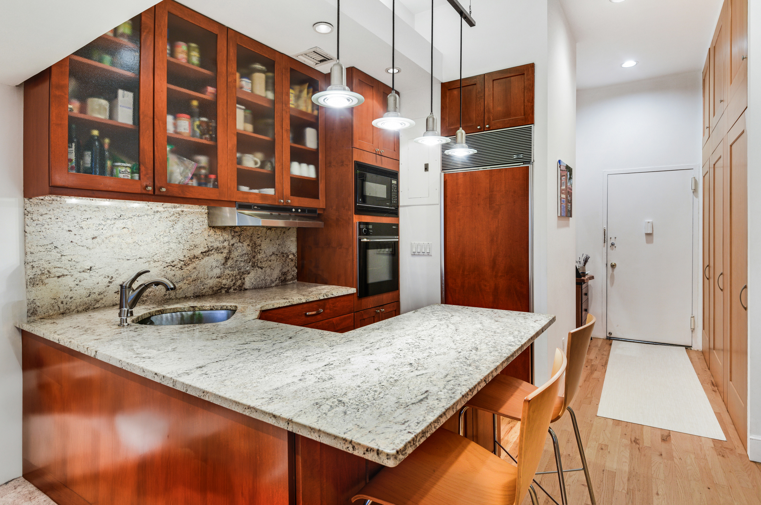23 Waverly Place, Unit 5U Manhattan, NY 10003 - Photo 3 of 13 a kitchen with a table and chairs in it
