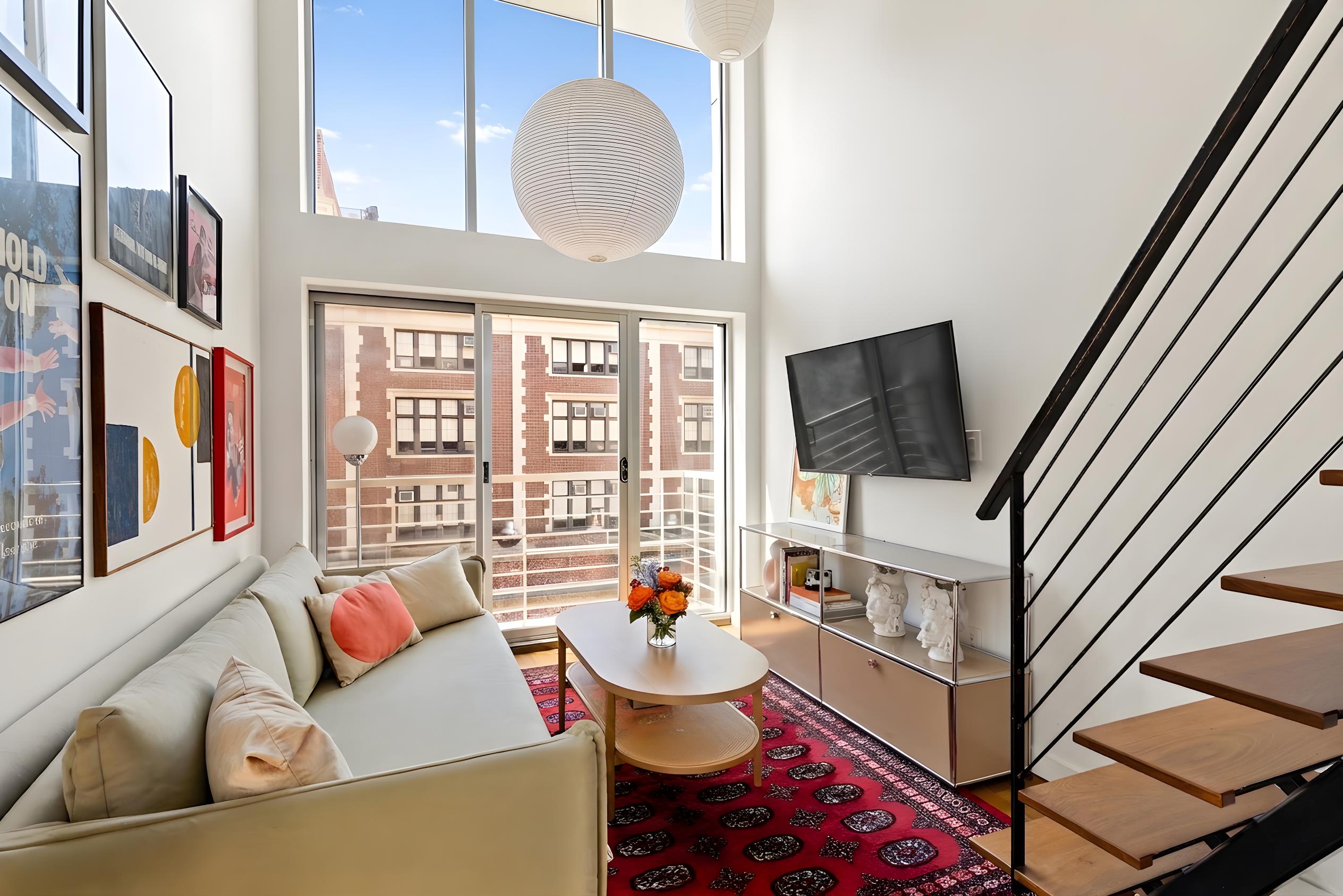 335 Warren Street, Unit 401 Brooklyn, NY 11201 - Photo 2 of 15 a living room with furniture and a flat screen tv