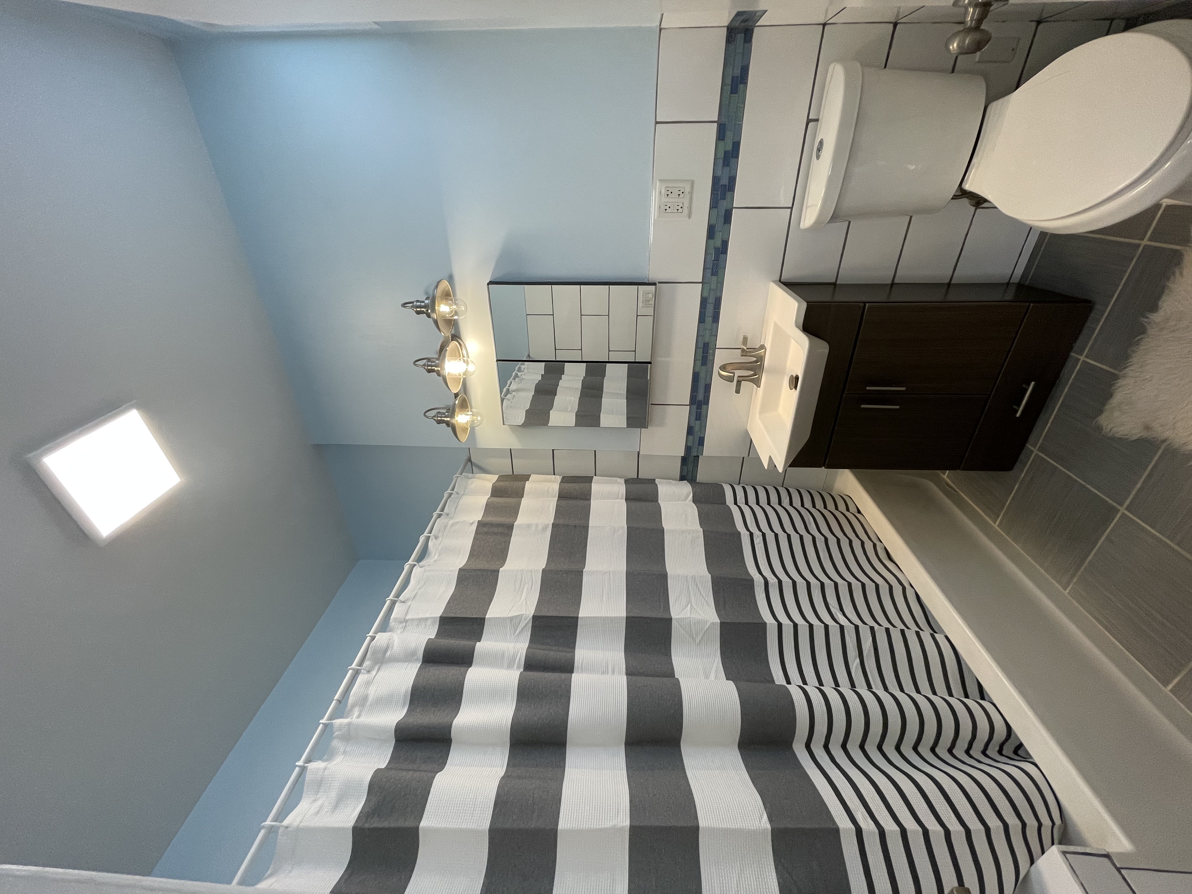 2446 Bedford Avenue, Unit 1 Brooklyn, NY 11226 - Photo 10 of 15 a bathroom with a sink toilet and shower