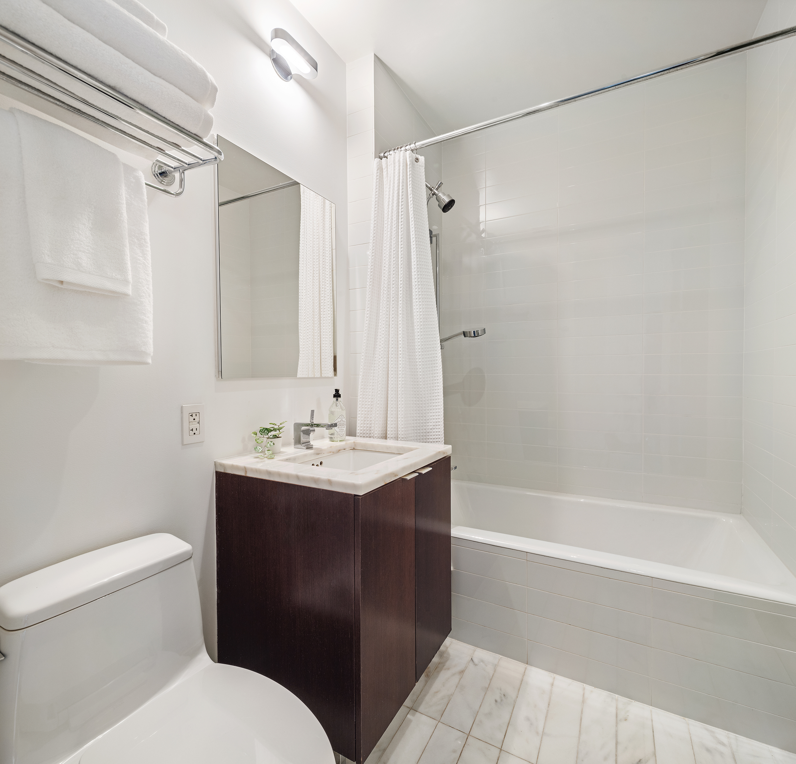 101 Warren Street, Unit 11L Manhattan, NY 10007 - Photo 17 of 28 a bathroom with a sink a toilet and shower