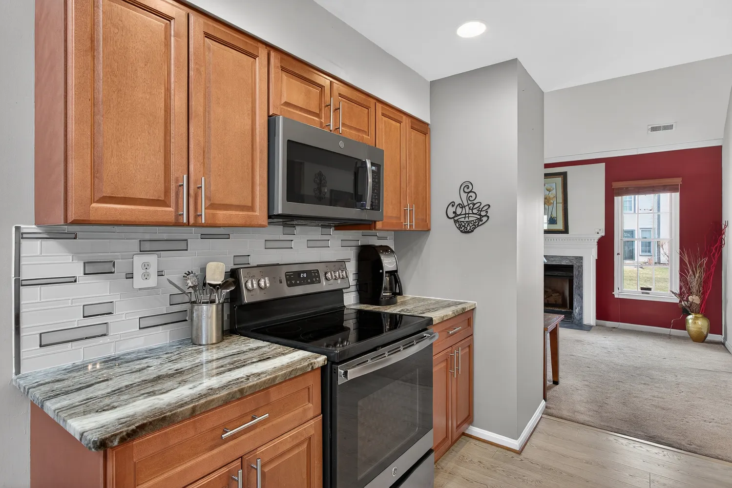 a kitchen with stainless steel appliances granite countertop a stove a sink and a microwave