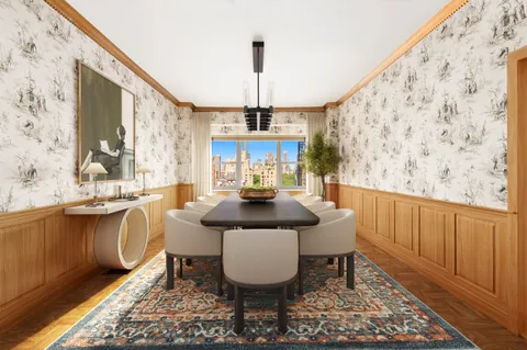 a dining room with chandelier and wooden floor