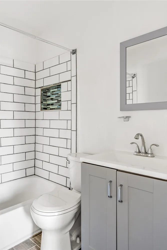 a bathroom with a sink toilet and mirror