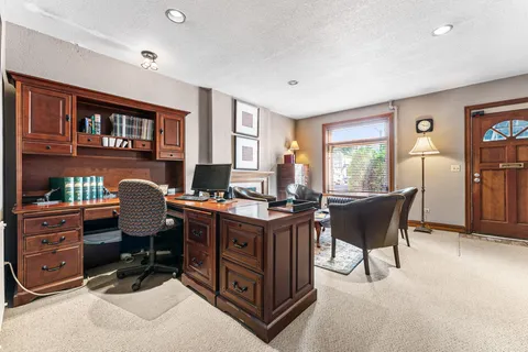 a bathroom with a granite countertop toilet sink and mirror