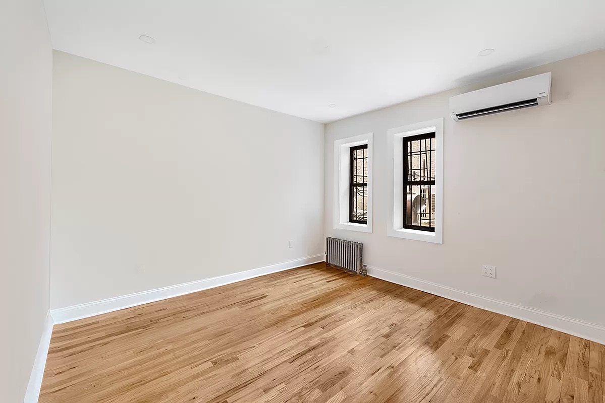 1097 Park Place, Unit 1 Brooklyn, NY 11213 - Photo 5 of 9 an empty room with windows