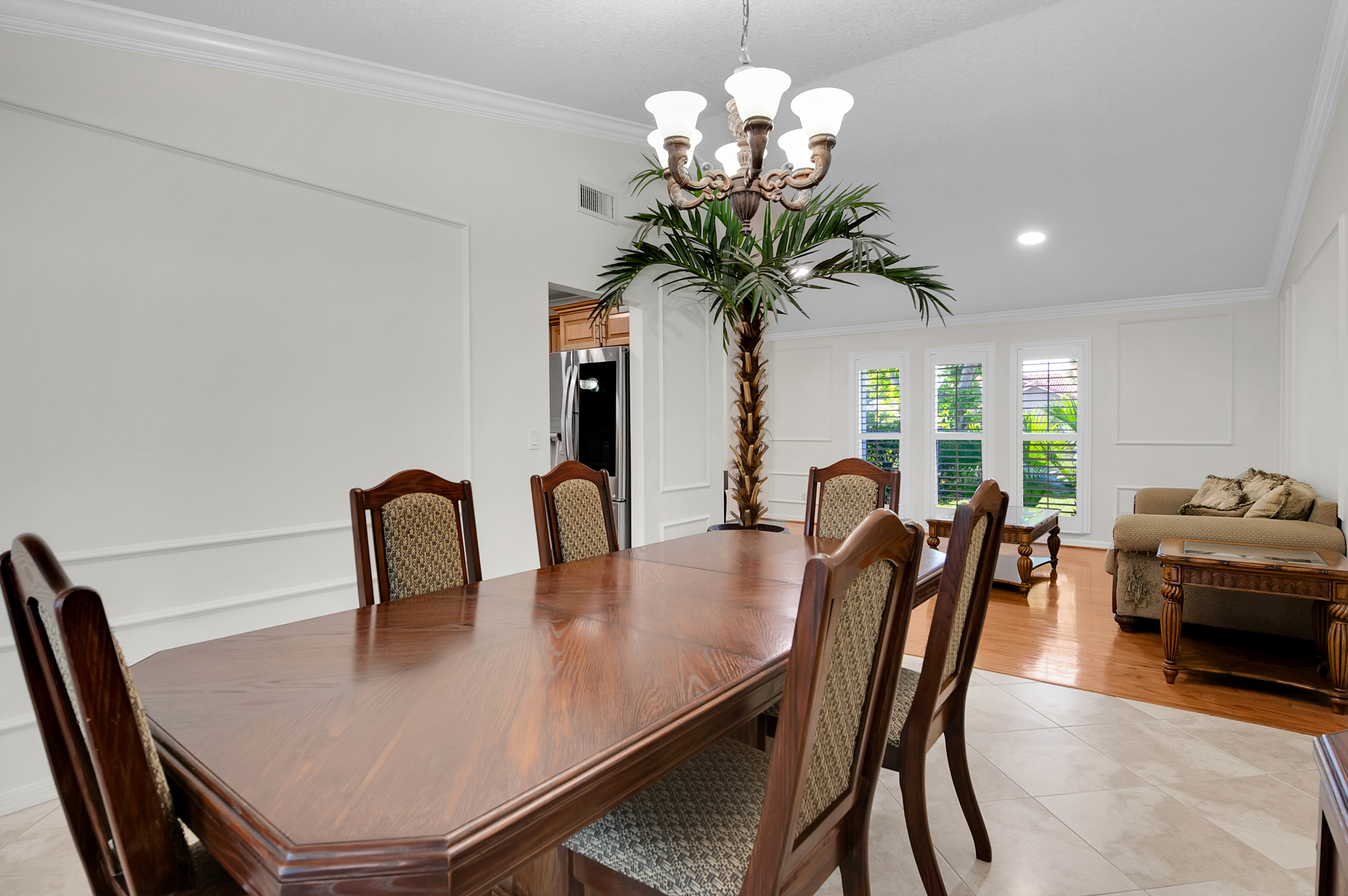 1560 Southwest 16th Street Boca Raton, FL 33486 - Photo 46 of 72 a view of a dining room with furniture a chandelier and wooden floor