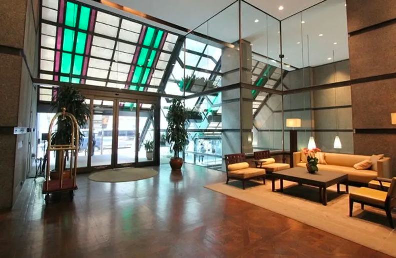 117 East 57th Street, Unit 35D Manhattan, NY 10022 - Photo 26 of 30 a lobby with furniture and floor to ceiling windows