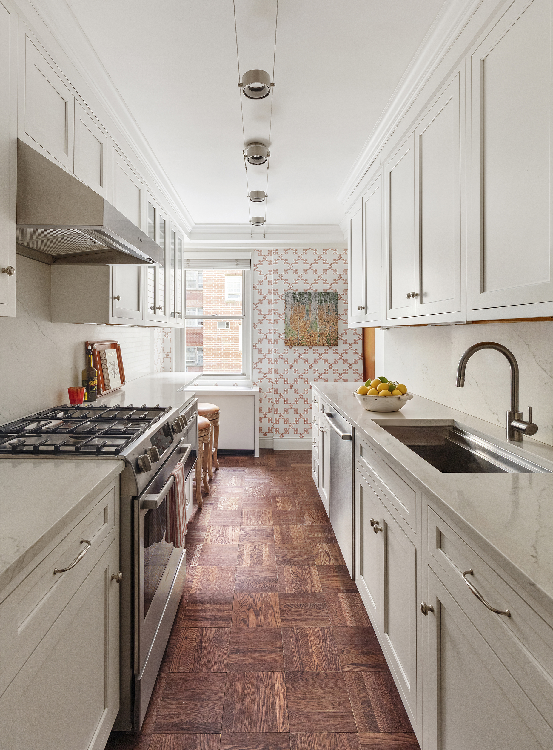 10 East 70th Street, Unit 3A Manhattan, NY 10021 - Photo 4 of 18 a kitchen with stainless steel appliances granite countertop a stove and a sink