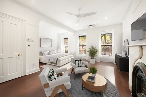 a living room with furniture a fireplace and a window