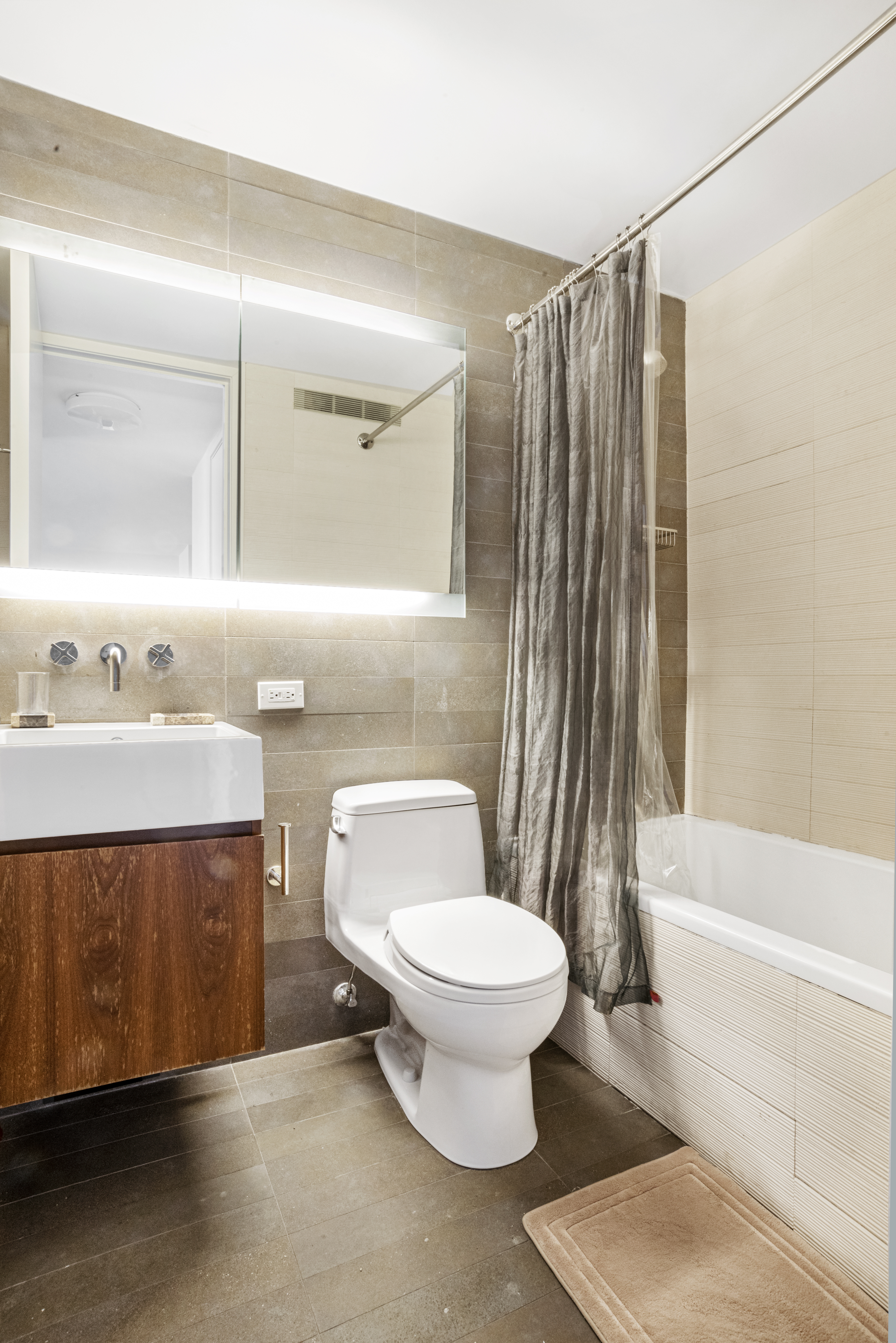 515 East 72nd Street, Unit 25E Manhattan, NY 10021 - Photo 7 of 11 a bathroom with a sink toilet and shower