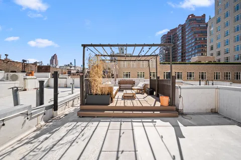 a view of a balcony with chairs and wooden floor