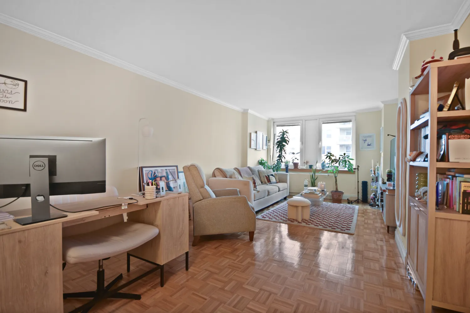 a living room with furniture and a book shelf