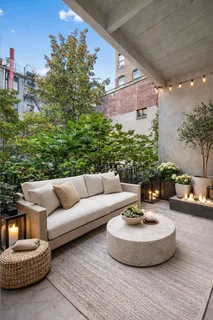 a living room with furniture and a potted plant