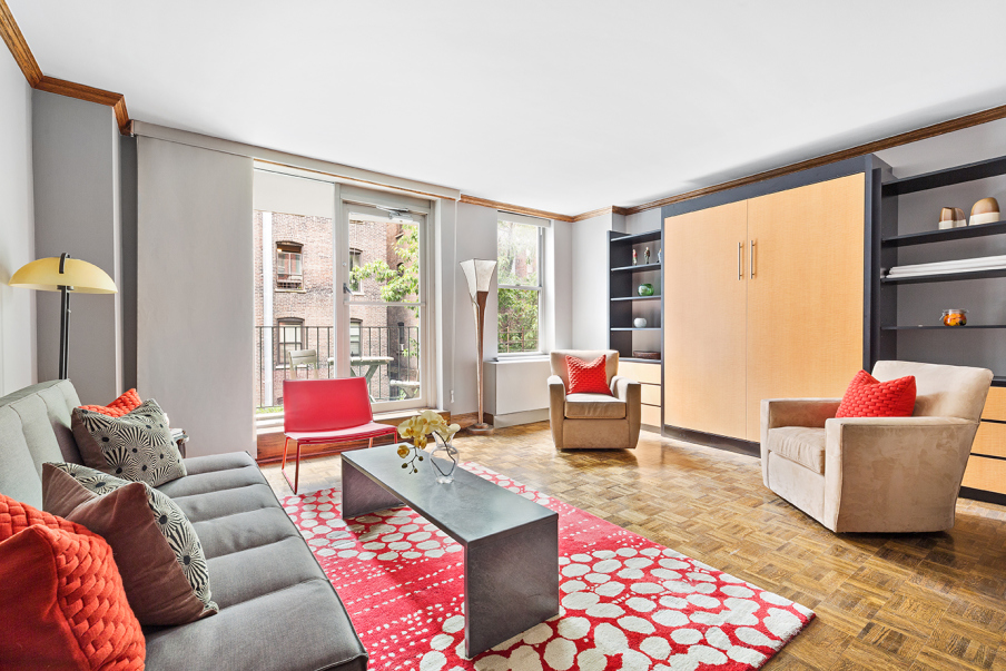 a living room with furniture and a floor to ceiling window