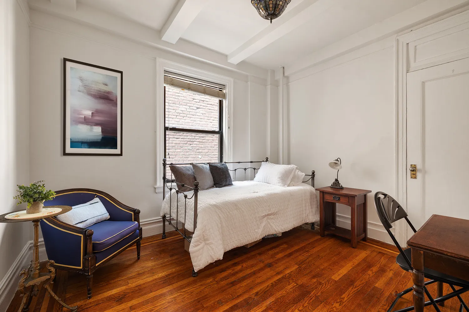 a spacious bedroom with a bed and a desk