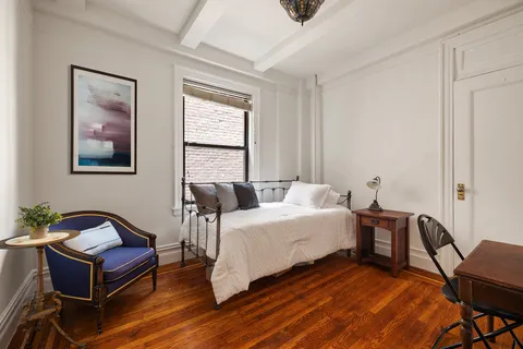 a spacious bedroom with a bed and a desk