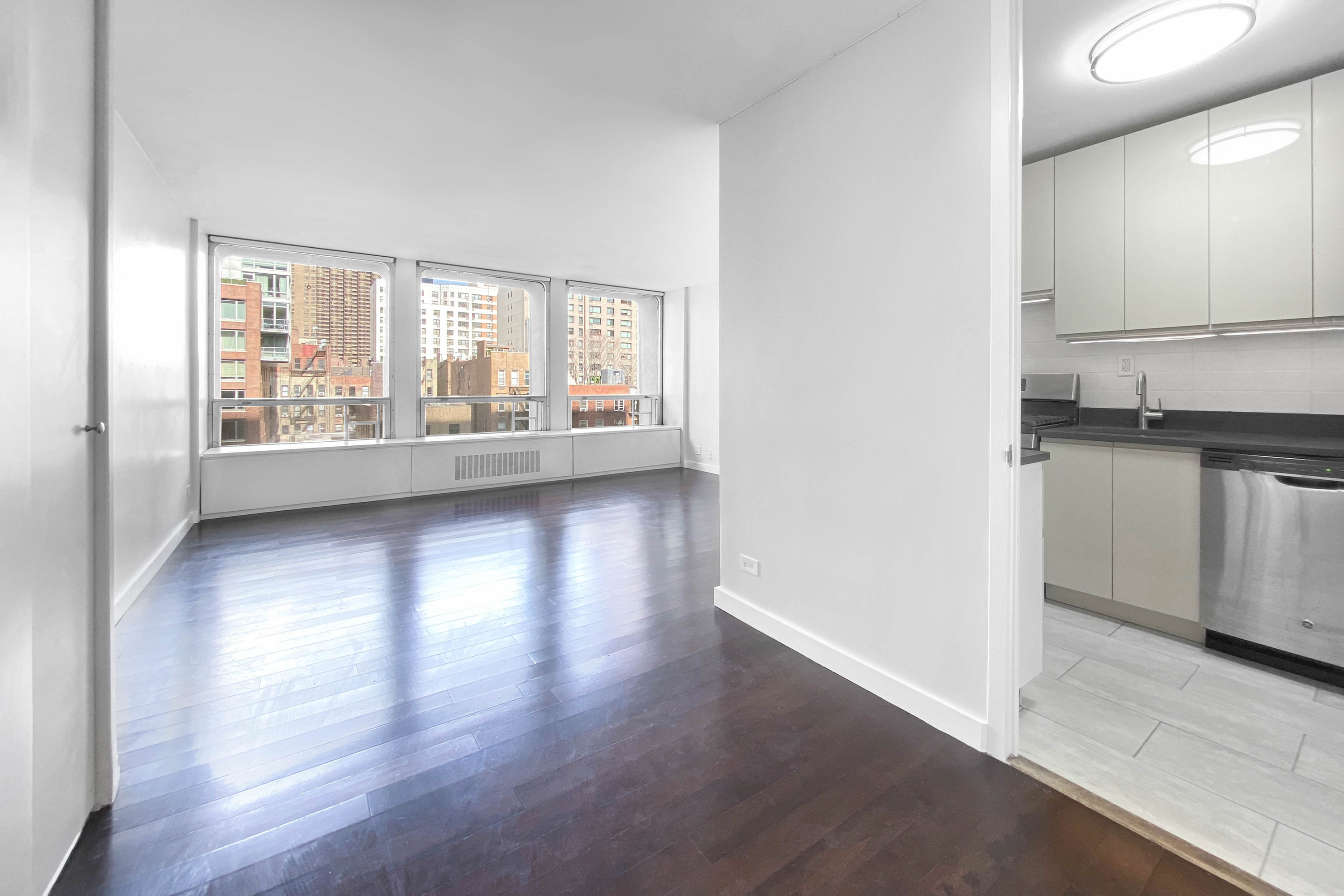 330 East 33rd Street, Unit 3F Manhattan, NY 10016 - Photo 3 of 15 a view of wooden floor and a kitchen in a room