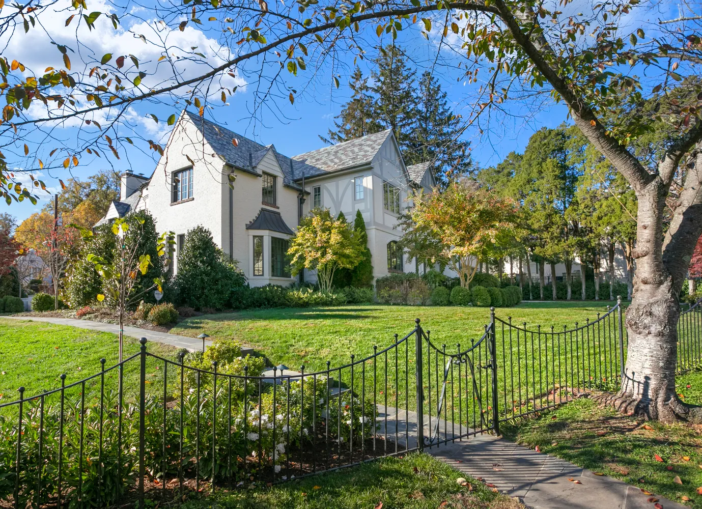a view of a house with a big yard and garden