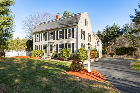 a view of a house with yard and sitting area