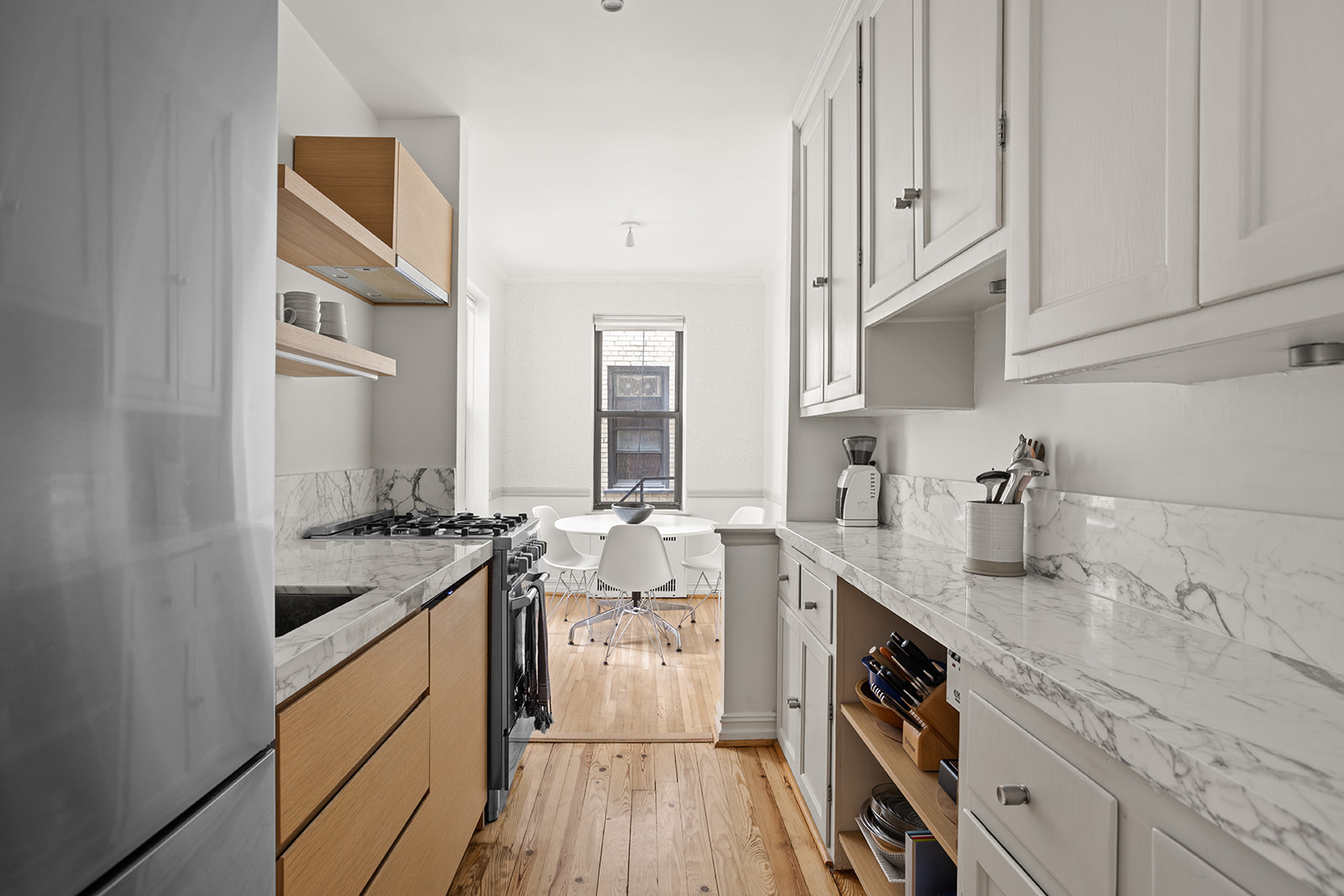 35-36 76th Street, Unit 123 Queens, NY 11372 - Photo 4 of 11 a kitchen with granite countertop a sink stove and cabinets