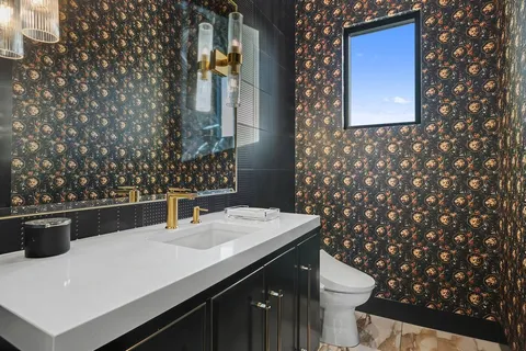 a bathroom with a sink toilet and vanity