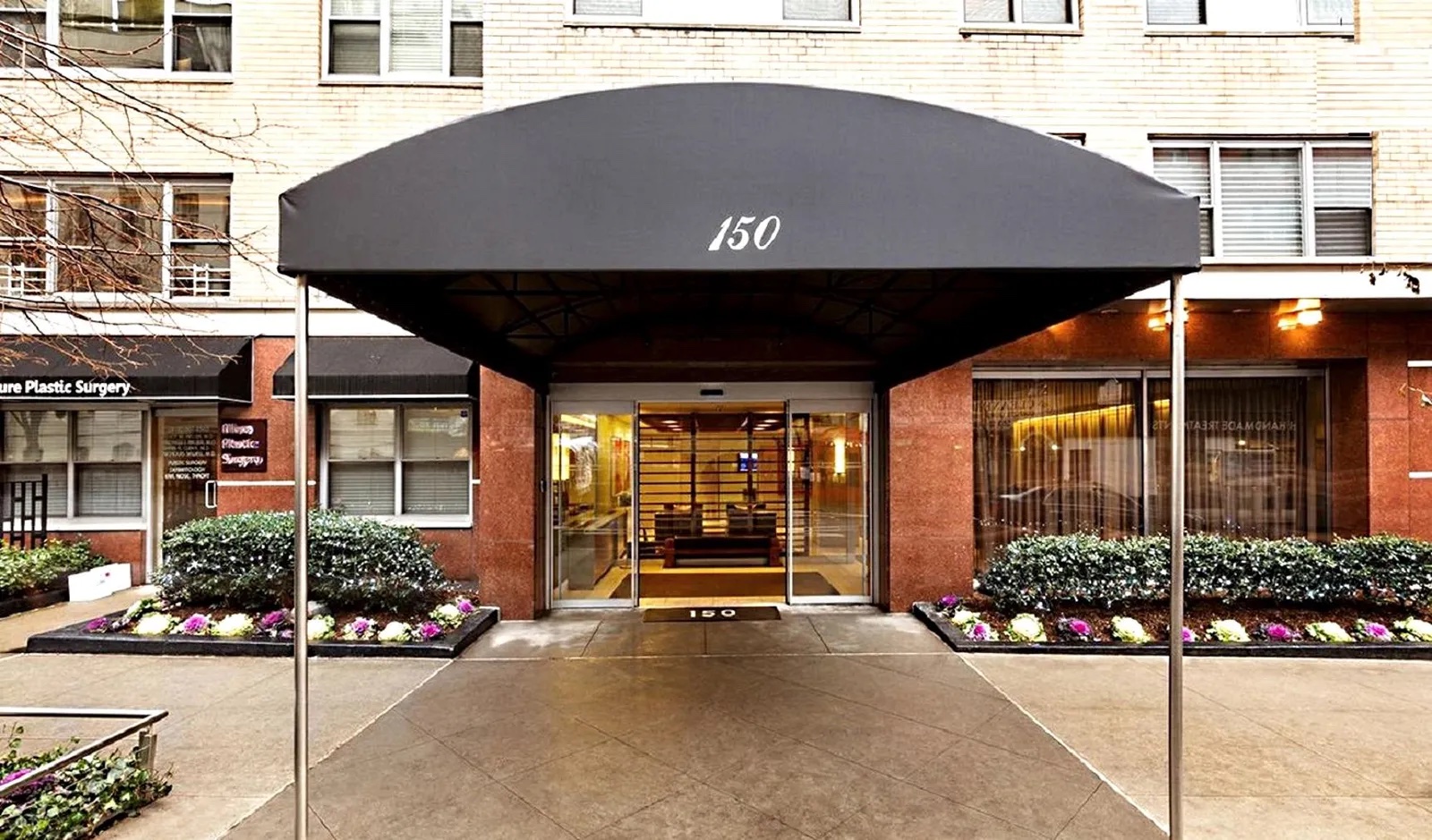 150 East 61st Street, Unit 8B Manhattan, NY 10065 - Photo 26 of 30 a front view of a house with a garden