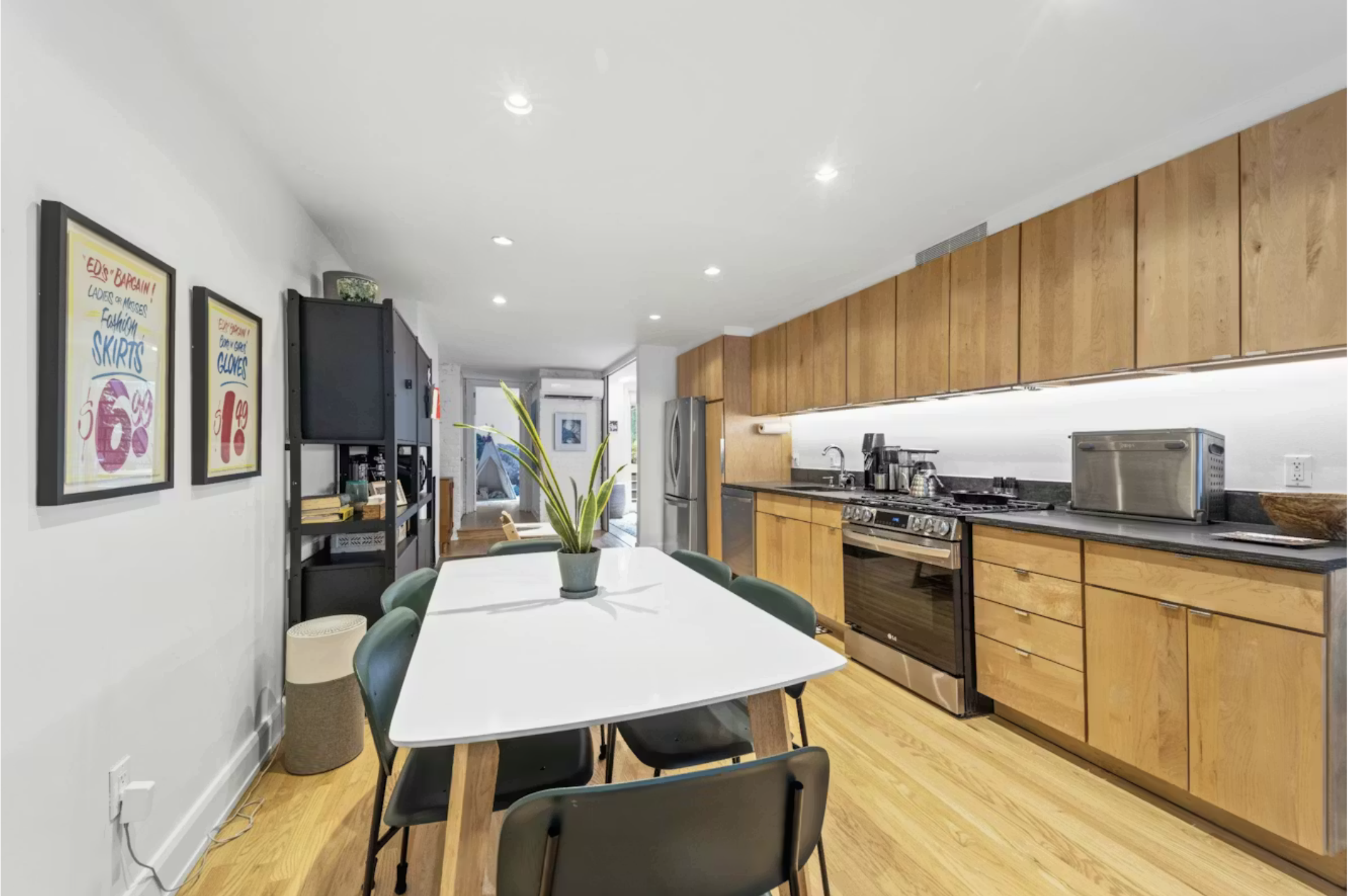 304 Warren Street, Unit 1 Brooklyn, NY 11201 - Photo 3 of 16 a kitchen with granite countertop kitchen island stainless steel appliances sink refrigerator dining table and chairs