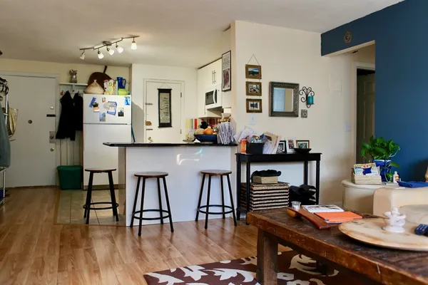 a view of a dining room with furniture and wooden floor