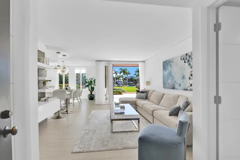 a living room with furniture large window and glass door