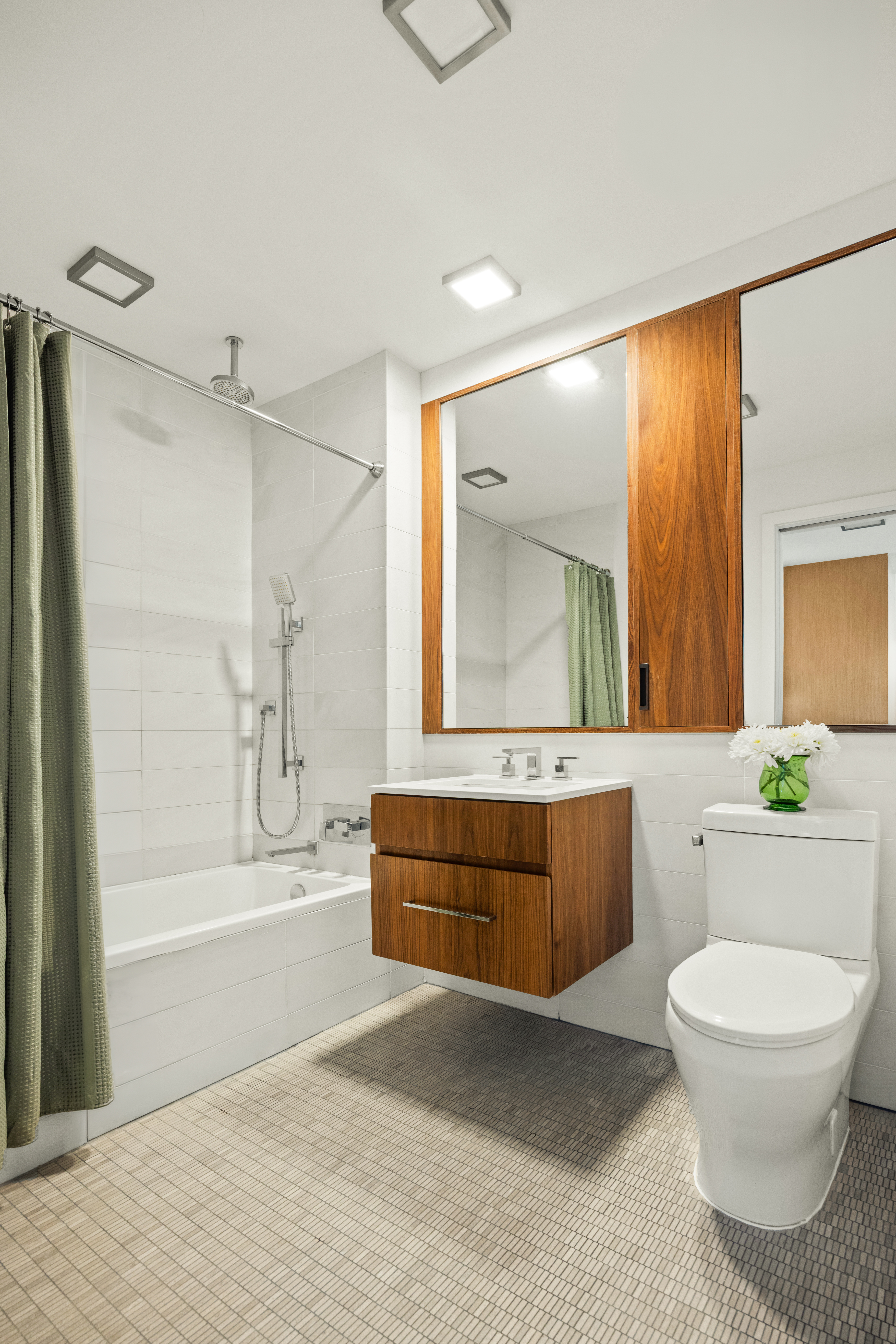 319 Schermerhorn Street, Unit 14A Brooklyn, NY 11217 - Photo 5 of 9 a bathroom with a granite countertop bathtub sink vanity mirror and toilet