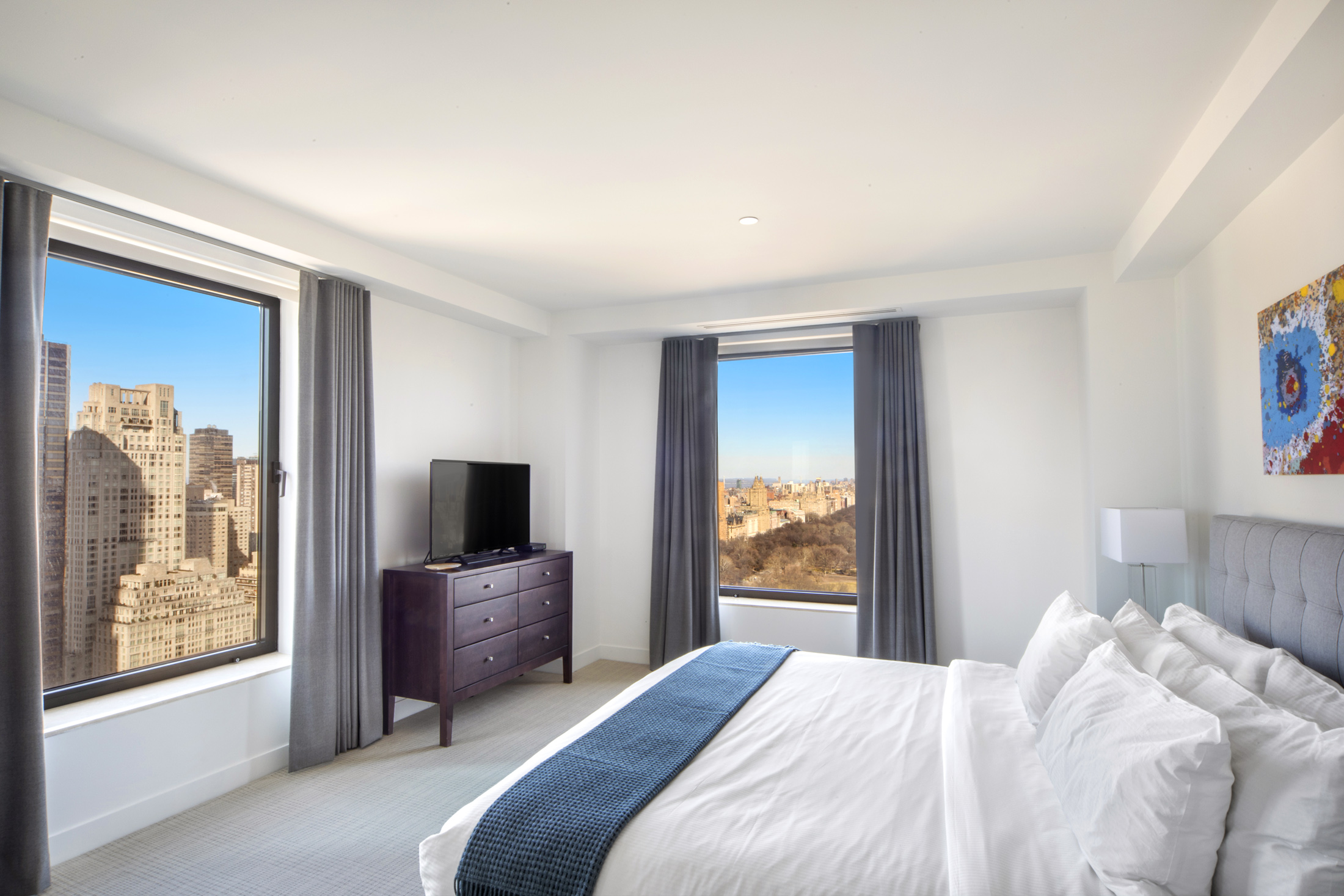 160 Central Park South, Unit 3903 Manhattan, NY 10019 - Photo 5 of 11 a bedroom with a balcony a bed and a television