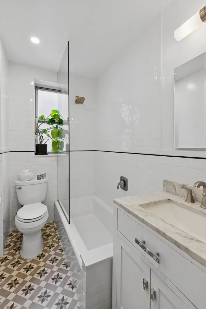 a bathroom with a sink toilet and shower