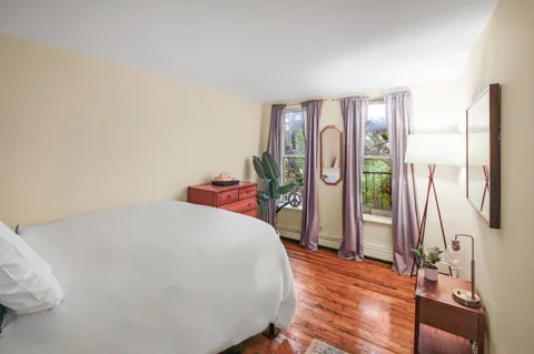 a bedroom with a large bed and a large window