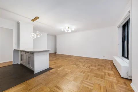 a view of a kitchen with cabinets and wooden floor