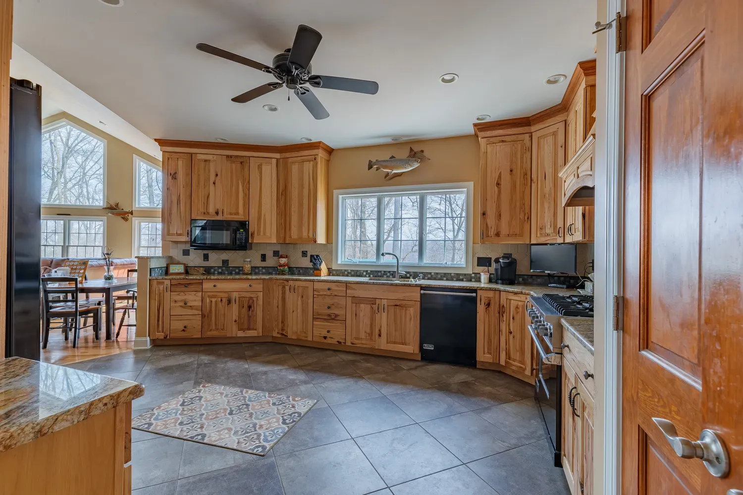 a bathroom with a granite countertop sink a toilet and shower