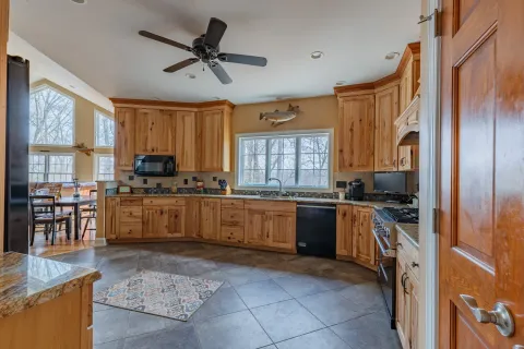 a bathroom with a granite countertop sink a toilet and shower