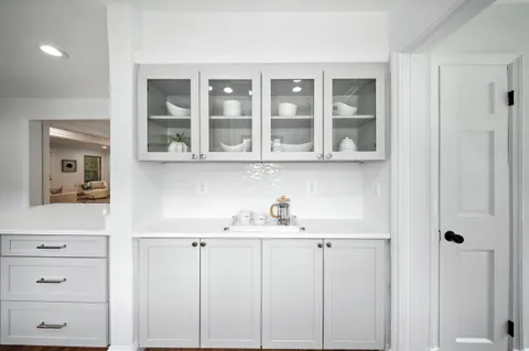 a kitchen with a refrigerator sink and cabinets