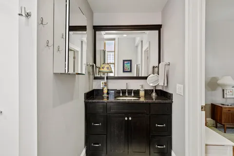 a bathroom with double vanity and a mirror