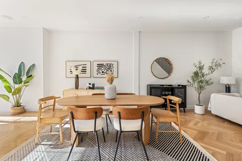 a view of a dining room with furniture and wooden floor