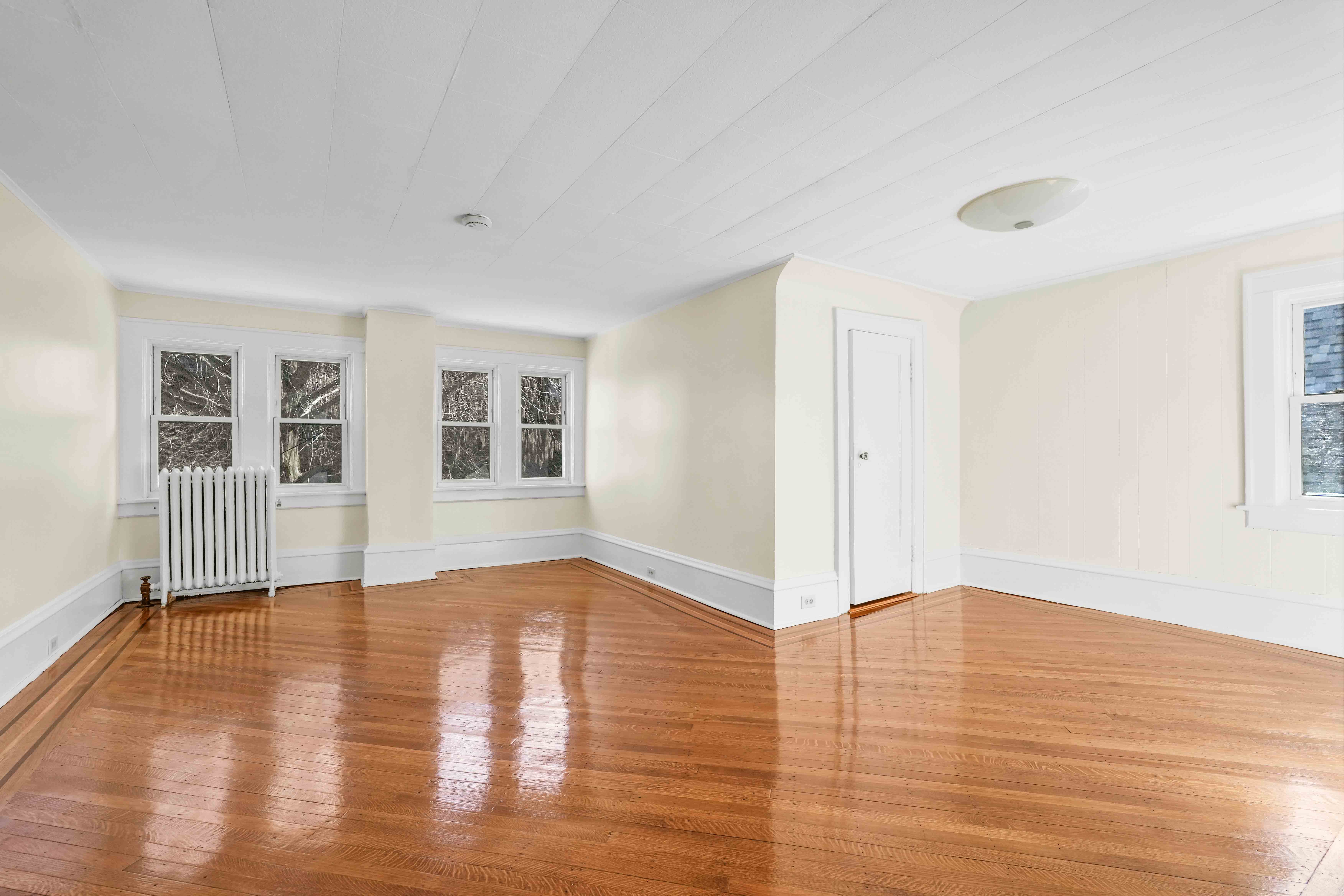 642 East 26th Street Brooklyn, NY 11210 - Photo 22 of 32 wooden floor in an empty room with a window