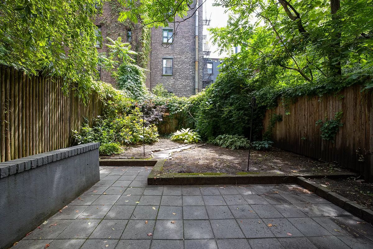 a view of a backyard with plants and trees
