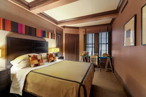 a bedroom with furniture and a flat screen tv