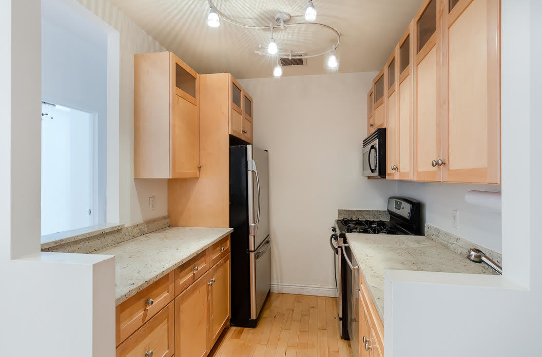 60 Tiffany Place, Unit 1A Brooklyn, NY 11231 - Photo 3 of 11 a kitchen that has a sink a stove and a refrigerator