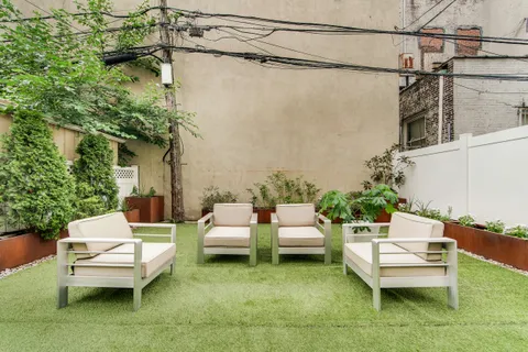 a swimming pool with outdoor seating and a couch