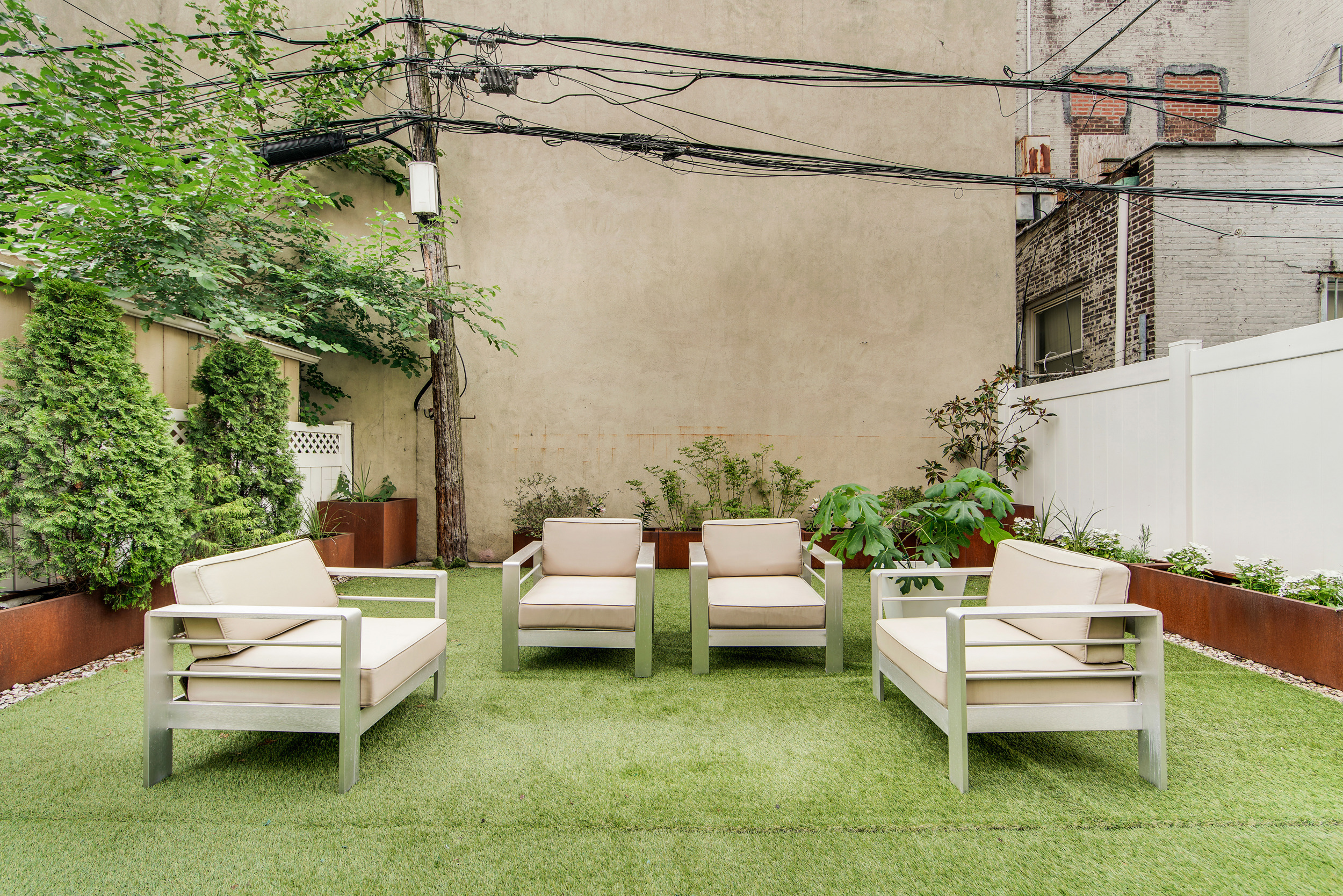 27-34 27th Street, Unit 1B Queens, NY 11102 - Photo 5 of 10 a swimming pool with outdoor seating and a couch