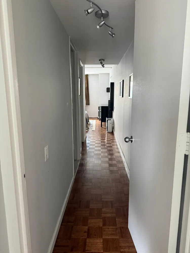a view of a hallway with furniture
