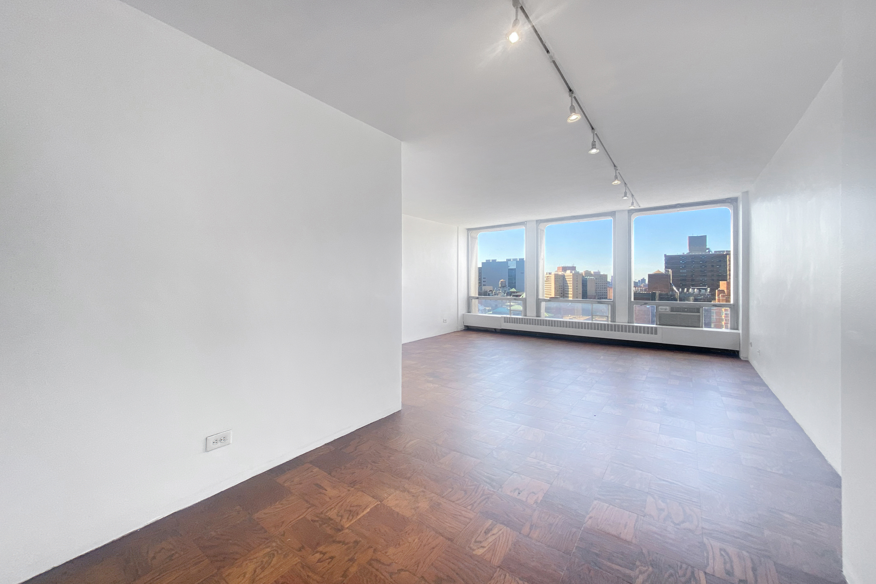 343 East 30th Street, Unit 19K Manhattan, NY 10016 - Photo 6 of 22 a view of an empty room with a kitchen