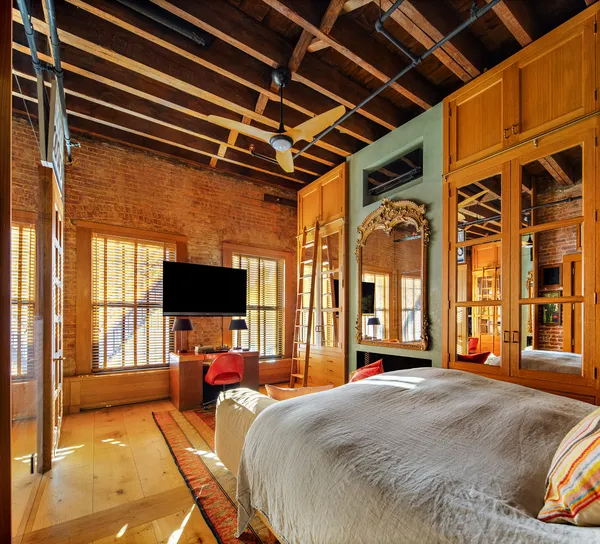 a bed room with a bed and a television