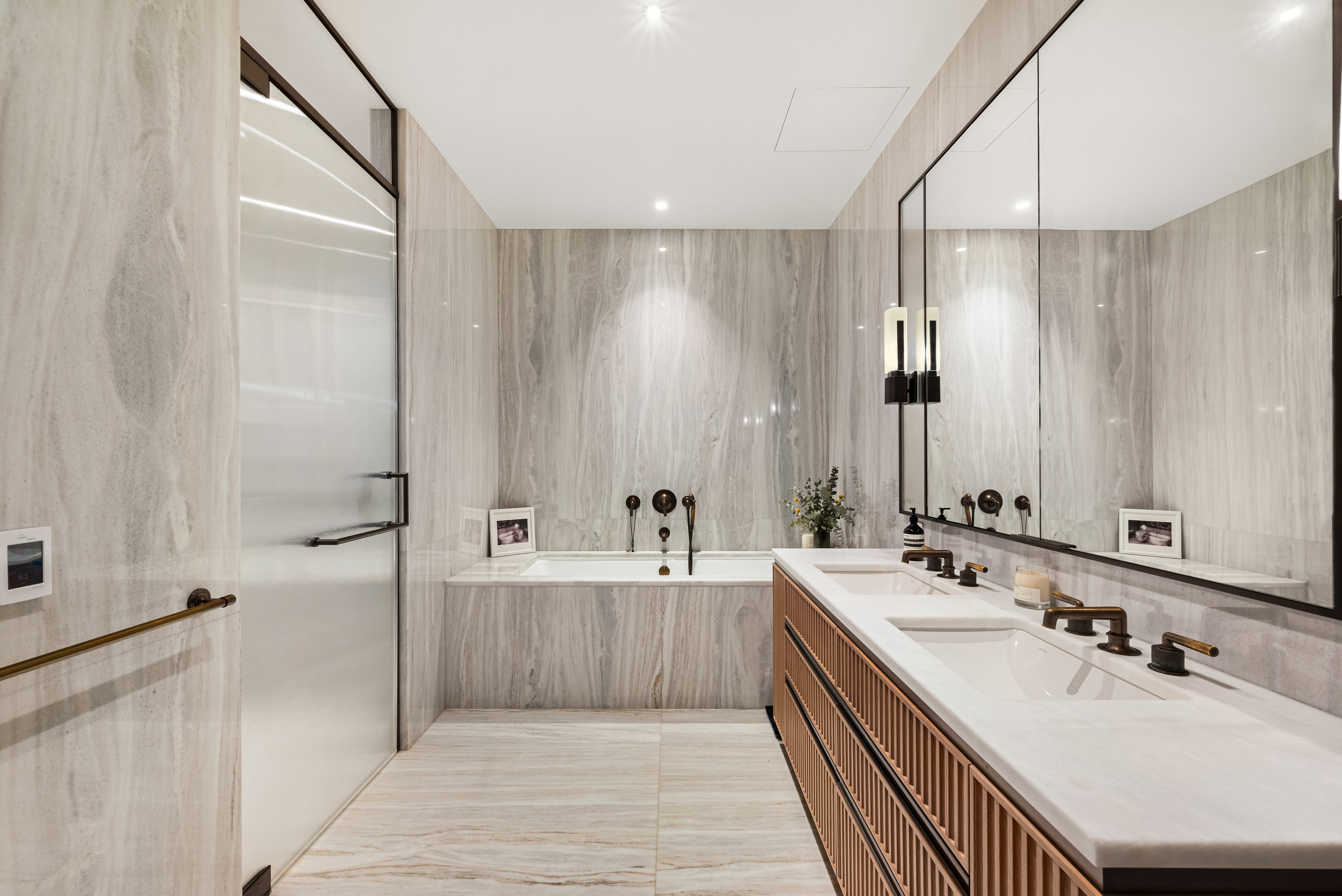 515 West 18th Street, Unit 901 Manhattan, NY 10011 - Photo 7 of 14 a bathroom with a double vanity sink a large mirror and shower