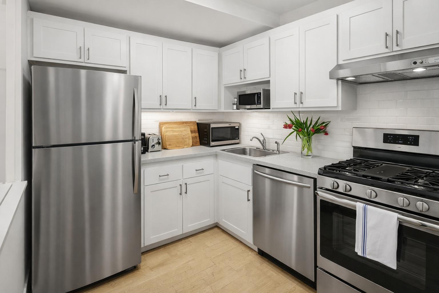 251 West 19th Street, Unit 1G Manhattan, NY 10011 - Photo 10 of 31 a kitchen with cabinets stainless steel appliances and wooden cabinets